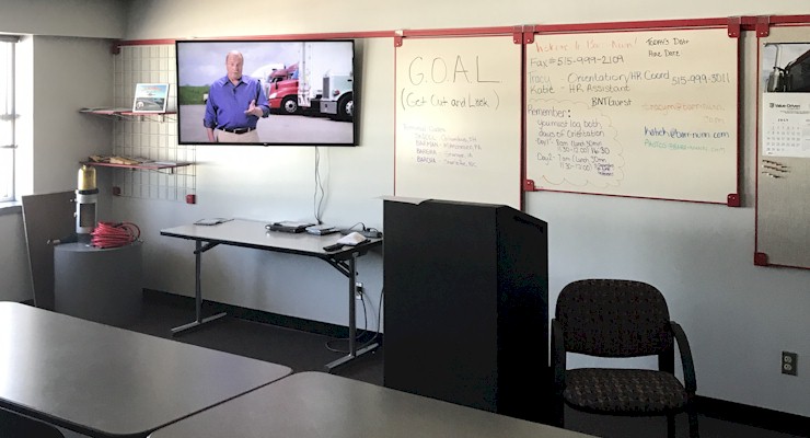 Barr-Nunn Des Moines, IA area truck driver training classroom showing desks, whiteboard, and company video